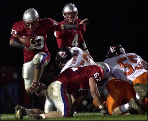 Patrick Henry's Josh Strub leaps over a teammate to gain ground last night against Liberty Center.