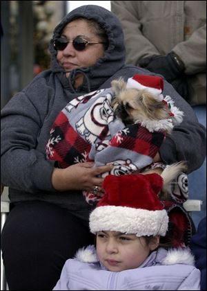 Roberta Snow-Quintanilla, her dog Chulo, and granddaughter Rebecca Martinez, 8, were bundled up for the cold.