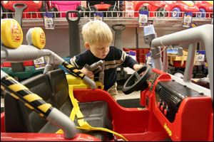 Bryce Amstutz, 3 , gives his vote to the Fire Rescue Jeep, especially its water-cannon feature. 