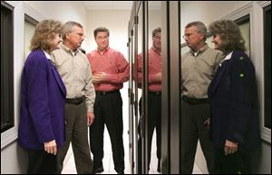 Lynn Child, John Haughawout, and Sean Burke, from left, reflect on the data center at CentraComm Communications Ltd., a computer networking and security provider.