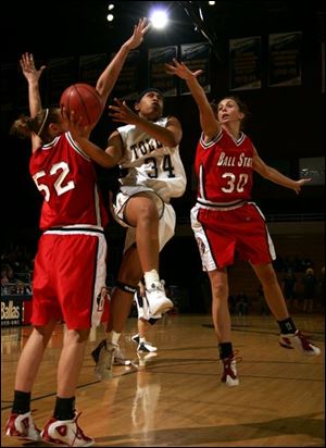 Toledo's Olivia Terry splits Ball State defenders Becca Bajorek, left, and Kate Endress during the second half.