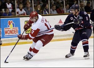 The Storm's Dan Eberly is hooked by Steve Dix of the Dayton Bombers last night at the Sports Arena.