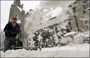 Jim Chamberlin puts his snowblower to good use clearing the St. Mark Lutheran Church sidewalk on Woodville Road. Mr. Chamberlin lives near the church and likes to be neighborly.