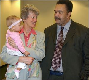 OHIO FAMILIES: Ohio's first lady, Hope Taft, holds Toledo Mayor Jack Ford's grandniece, Precious Watkins, during a vintage tea presented by the Toledo-Lucas County Public Library.