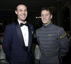 COMRADES AT ARMS: At left, Cadet Karlton Wolf of the Air Force, left, and Army Cadet Mike DeMichiei pose for a photo at the Military Service Academies Ball.