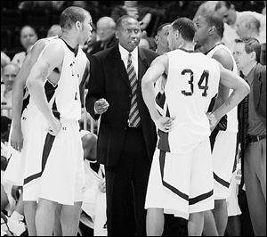 UT coach Stan Joplin talks with his team during last night's game.