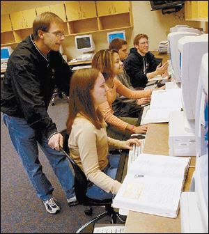 Math teacher Ray Pohlman assists, from left, Sarah Stuckey, Elizabeth Ransey, Justin Longenberger, and Jon Sladky.