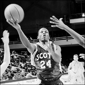 Trevor Alexander puts up a shot for Scott against St. John s last night at Savage Hall. St. John s handed Scott its first loss.
