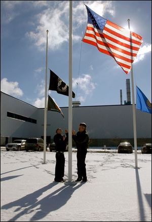 The fl ags outside the Toledo North Assembly plant are lowered to half staff. Production was scheduled to resume today.
