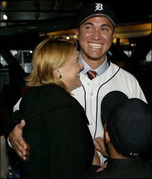 Magglio Ordonez hugs his wife, Dagly, after being introduced to the media in Detroit yesterday. Hurt much of last season, he will be plugged into the Tigers' cleanup spot.