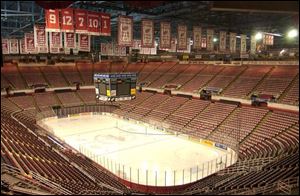 Joe Louis Arena, with banners signifying past glory, stands empty on the day the hockey season was officially canceled. 