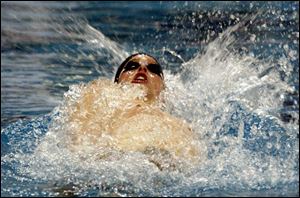 Jacob Busch of Toledo Christian wins the 100-yard backstroke in the district meet yesterday at BGSU s Cooper Pool. The senior was second in the 100-yard freestyle.
