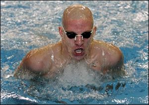 St. Francis  Mike Carroll pops out of the water after fi nishing second in the 200 individual medley. He won the 100 butterfly.