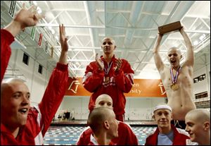 St. Francis de Sales swimmers and divers never seem to tire of celebrating district championships - 40 in a row now. Jacob Busch of Toledo Christian wins the 100-yard backstroke in the district meet yesterday at BGSU's Cooper Pool. The
senior was second in the 100-yard freestyle.