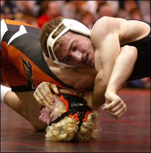 Delta's Jamison Moss, right, takes down Liberty Center's Marc Hoff in the 145-pound district final. Moss won 9-6. 