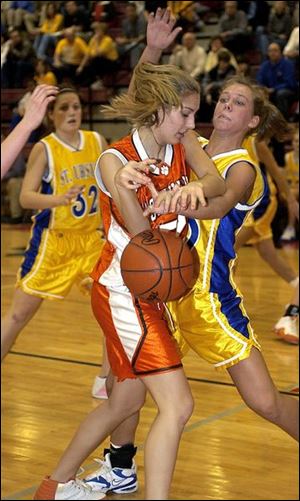 St. Ursula's Joan Anderson knocks the ball away from Southview's Mandi Lisk in last night's sectional championship.