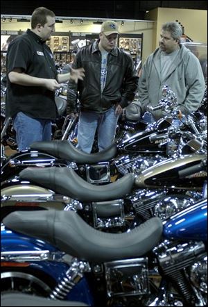 Vic Vargas, center, and Mark Moses, right, both of Michigan, tour the Sylvania Township Harley-Davidson Buell location.