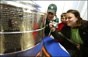 Jeff Antonelli, Elijah Owens and his mother Michele Antonelli, all from Michigan, enjoy being close to the fabled Stanley Cup.