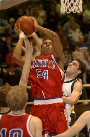 St. Francis' Marlon Price elevates
above the Clay defense to score two of his 10 points last night at Libbey.