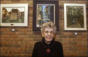 Ella Mae Peters, at the Tiffin-Seneca County Library in Tiffin, spent most of her 87th birthday on Monday preparing more than 40 pieces of her artwork for display at the library.