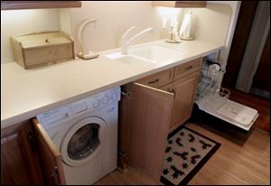 Kathy Foley s kitchen includes a built-in washer/dryer, left, and an 18-inch-wide dishwasher.