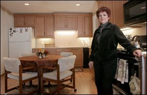 Kathy Foley of West Toledo in her newly redesigned kitchen.  I spent 10 years planning and dreaming,  Mrs. Foley says. And now that the project is
complete,  I love my kitchen. I love to cook. My husband asked me,  Can we go out to eat ever again?    