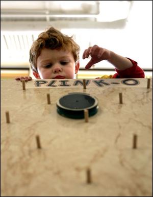 NBR luckey05p 01 - Little Hunter Shiffler, 3, plays plinko at the Luckey Elementary school carnival. The Blade/Allan Detrich