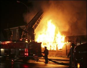 A spectacular fire lights up the night sky in the 1400 block of South Avenue in South Toledo. Last night s blaze engulfed at least two businesses, a lawnmower repair shop and a martial arts studio. 