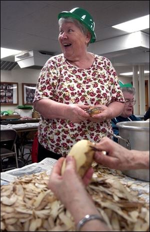 CTY peeling15p A -- Hilde Wilson has a laugh as she peels potatoes with other members of St. James Church, Tuesday, 03/15/05. Members of the church were getting ready for their St. Patrick's Day dinner, peeling potatoes, carrots and onions, as well as preparing the cabbage. The Blade/Andy Morrison