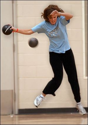 Lisa Genson avoids a dodgeball during a match.  I just
dodge. That s my theory,  said the mother of three children from Bowling Green.  Dodge, duck, dip, dive, and dodge. 