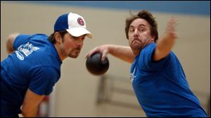 Lee Daher, left, follows through as Adam Brady takes aim in adult dodgeball in the YMCA s Fort Meigs Center for Health Promotion in Perrysburg.