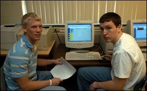 Dewey Russeau, left, and Nick Owens, both 17, have been busy hammering away on a special project: a Web site for Erie Township.
