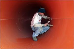 ROV Kalahari29p 2 .jpg   J.R. Pickard, an employee of Whitewater West, works on the inside of a waterslide called Zip coaster that is to be installed at the new Kalahari Resort on route 250 in Sandusky,OH 03/29/2005. The Zip Coaster is the only water slide of its type in the country.