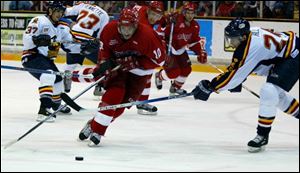 The Storm's Carl Mallette beats Peoria's Ed Hill, right, to the puck last night at the Sports Arena.