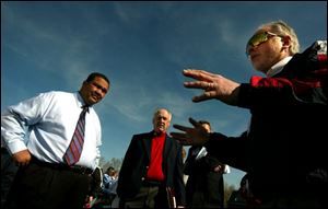 Mayor Jack Ford, left, and Toledo Storm statistician Ray King chat with former Storm owner Barry Soskin in the parking lot of the Sports Arena about how to save the franchise.