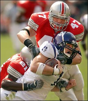 A.J. Hawk (47) helps stop Northwestern's Ray Bogenrief. Hawk has led Ohio State in tackles the past two seasons.