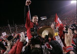 Urban Meyer is carried off the field after his Utah team blasted Brigham Young 52-21 last November. Utah finished 12-0.