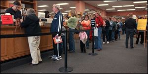 Employees help long lines of customers on the final day.