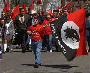 Nicholas Cabanillas, 11, carries a Farm Labor Organizing Committee fl ag down Broadway.
