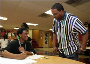 NBR club08p 16 year-old Brandon (cq) Ellis, a Scott High School student and a junior staff member at the Boys & Girls Club in Toledo, Ohio, left, and Greg Harris, Unit Director for the club, in the art room on April 8, 2005.  The Blade/Jetta Fraser