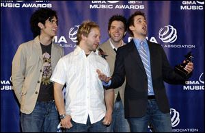 Sanctus Real's Chris Rohman, Mark Graalman, Steve Goodrum, and Matt Hammitt at Dove Awards. Toledo Christian rock band Sanctus Real won its first Dove Award in Nashville, taking home the Modern Rock Album of the Year Award for its 2004 release, 