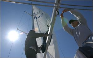 In a scene repeated across Ohio this weekend, Michael Taylor, left, of Taylor Marine Inc. in Vermilion, Ohio, and Bryce Custer of Canton, Ohio, prepare Mr. Custer's boat for the season.