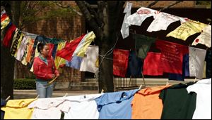 CTY clothesline22p 1 Freshman Lindsay Woods looks at the Clothesline Project on display Thursday, 04/21/2005, at Bowling Green State University in Bowling Green, O. The display of about 500 shirts is intended to create awareness about violence against women. The Blade/Jeremy Wadsworth