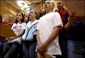 NBR camp23p    Brandy DePew, far right, in white shirt sing along with the rest of the choir from East Toledo Junior High, singing in the gym Saturday morning 4/23/05 .  Outside activites of the Civil War were rather damp due to the rain.  The Blade/Madalyn RUggiero