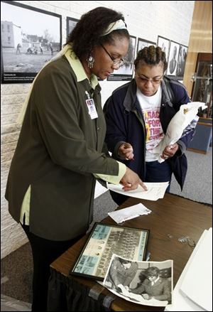 Pauline Kynard, left, and Shirley L. Spencer-DeGoldsby scan photos at the library as a way to preserve African-American history.