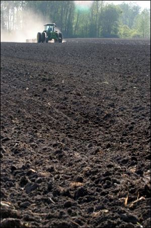 Gary Strain of Tom Strain & Sons readies a field. The market took in $286,500 in coupons from seniors last year.