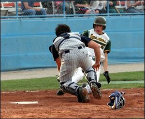 St. John s catcher Blake Haudan tags out Start s Jason Moulton on this play, but Moulton went 4-for-4 with three RBIs.