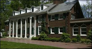 A Georgian Colonial on Ridgewood Road on Ottawa Hills is one of the highest-priced, at $1.5 million. The 8,600-square-foot house, built in 1917, commands a panoramic view. In the island kitchen, listing agent Nancy Lohman awaits a client. blade photos/diane hires A three-year-old, 5,555-square-foot house in Monclova Township has five bedrooms on three floors and is priced at $1.3 million. 