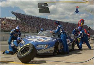 Rusty Wallace's crew works on his car yesterday during a pit stop in the Batman Begins 400 at Michigan International Speedway. Wallace finished 10th and is eighth in the point standings.