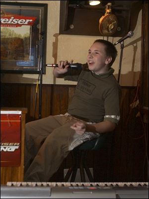 Nathan Walker, 13, performs his music for the first time at Delaney's Lounge on West Alexis Road. The eighth grader at Arbor Hills Junior High in Sylvania suffers from spina bifida.